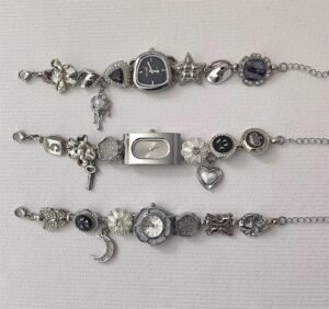 Bold Y2K wristwear bracelet incorporating charm sets and layered button interaction