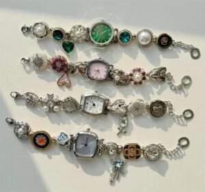 Artisan stainless steel fashion watch bracelet using mini charm attachments and button locks