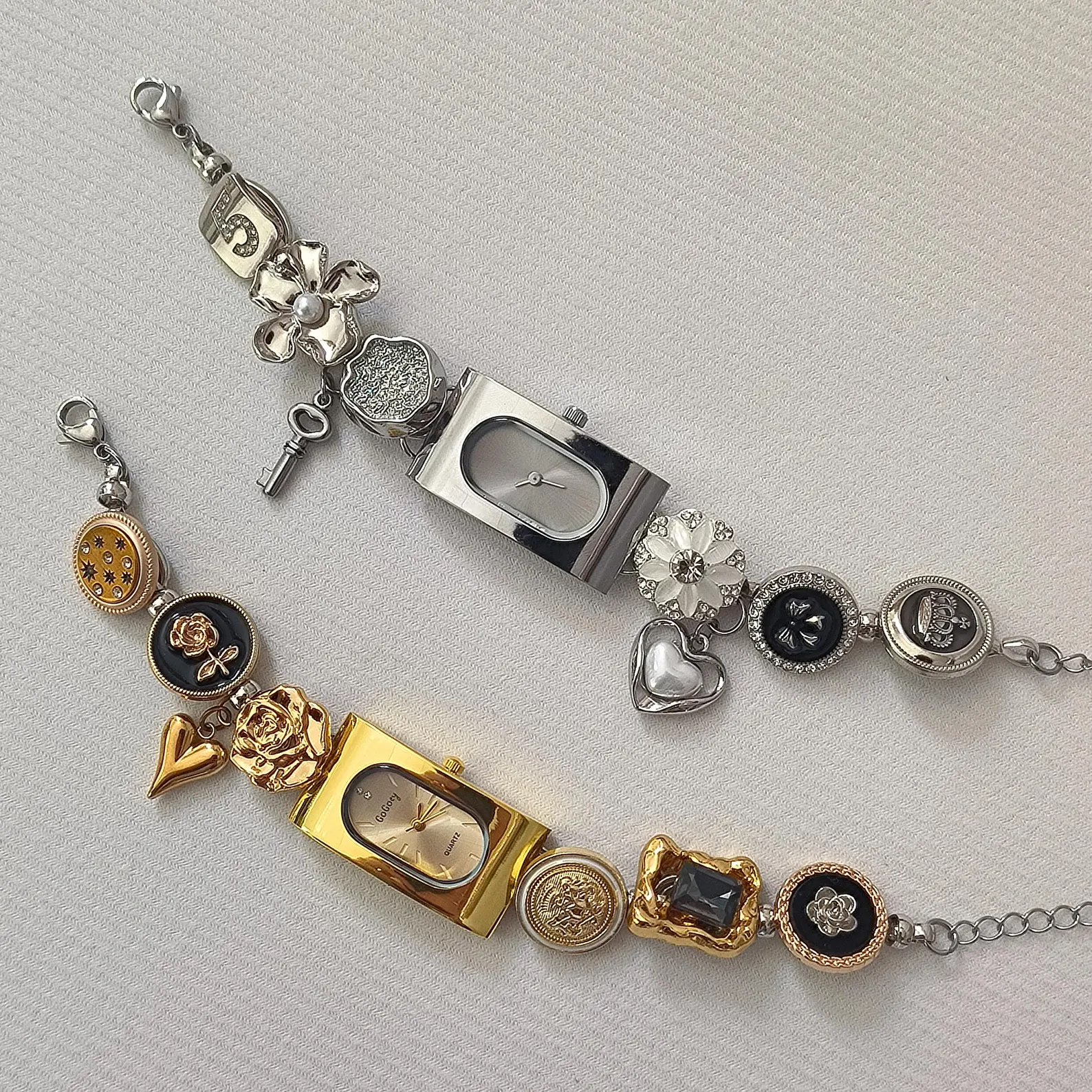 Statement watch bracelet featuring lock charms and layered button links