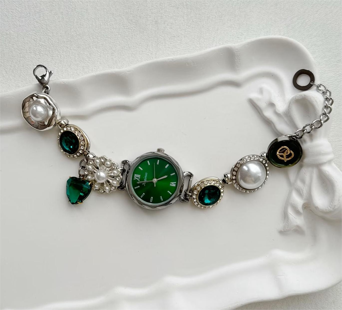Titanium watch bracelet tailored for fashion-forward looks using charm accents and metal buttons