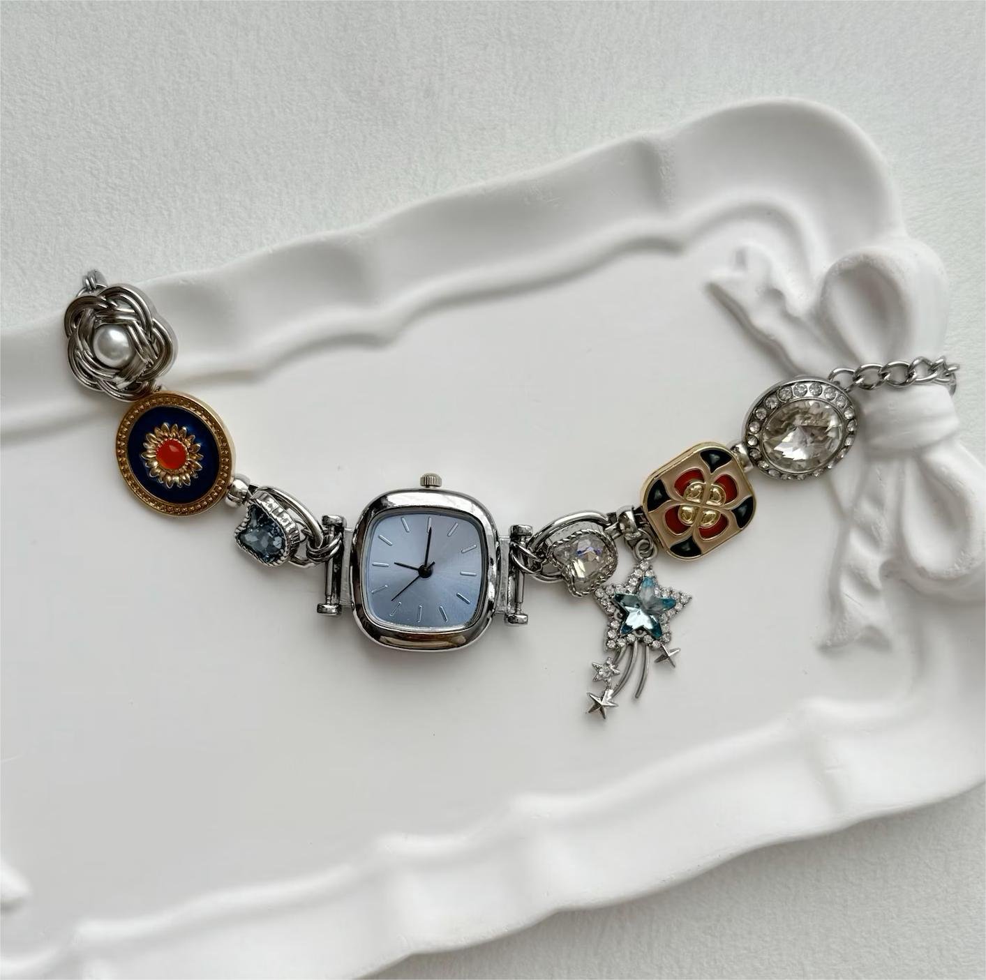 Y2K wrist bracelet watch presenting angular charm design and recessed button tools