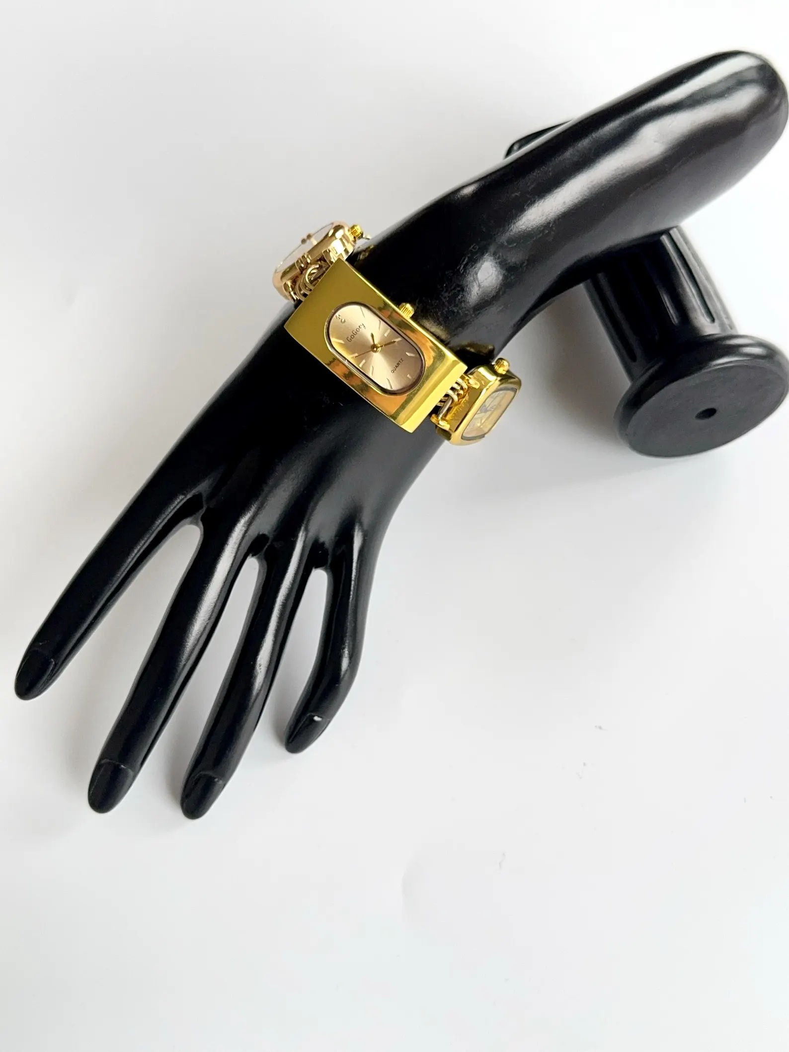 Gold Contemporary stainless bracelet watch styled for charm shift and mechanical button joints