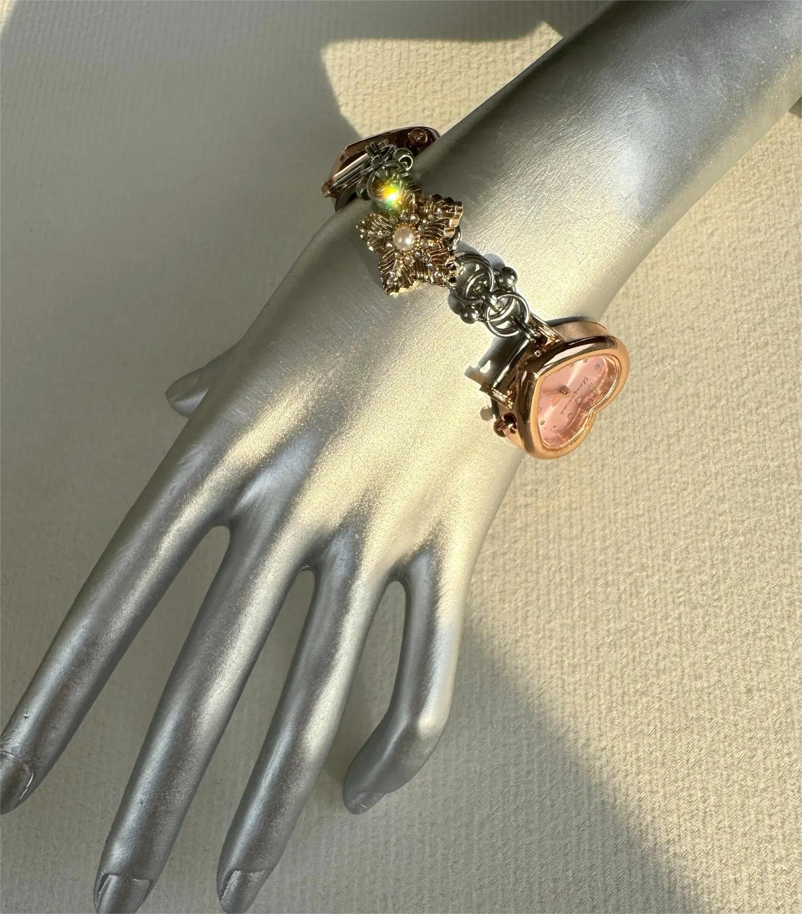 High-shine bracelet watch in stainless steel designed for charm-movement dynamics