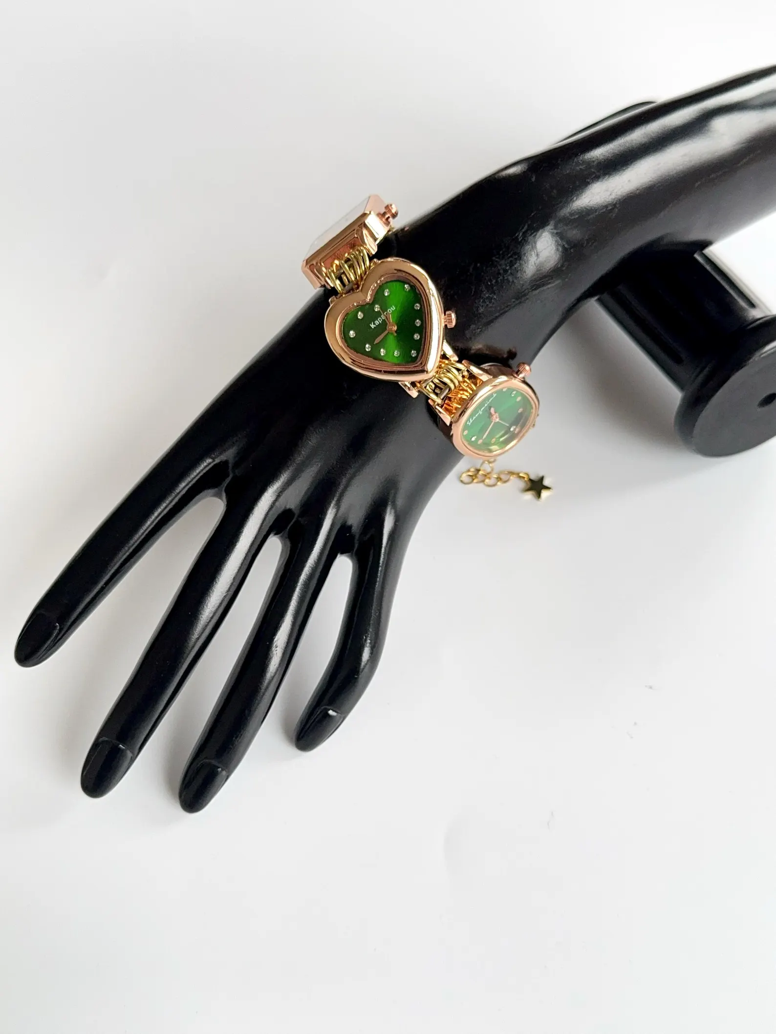 Futuristic watch bracelet made of stainless steel, button-focused styling and charms