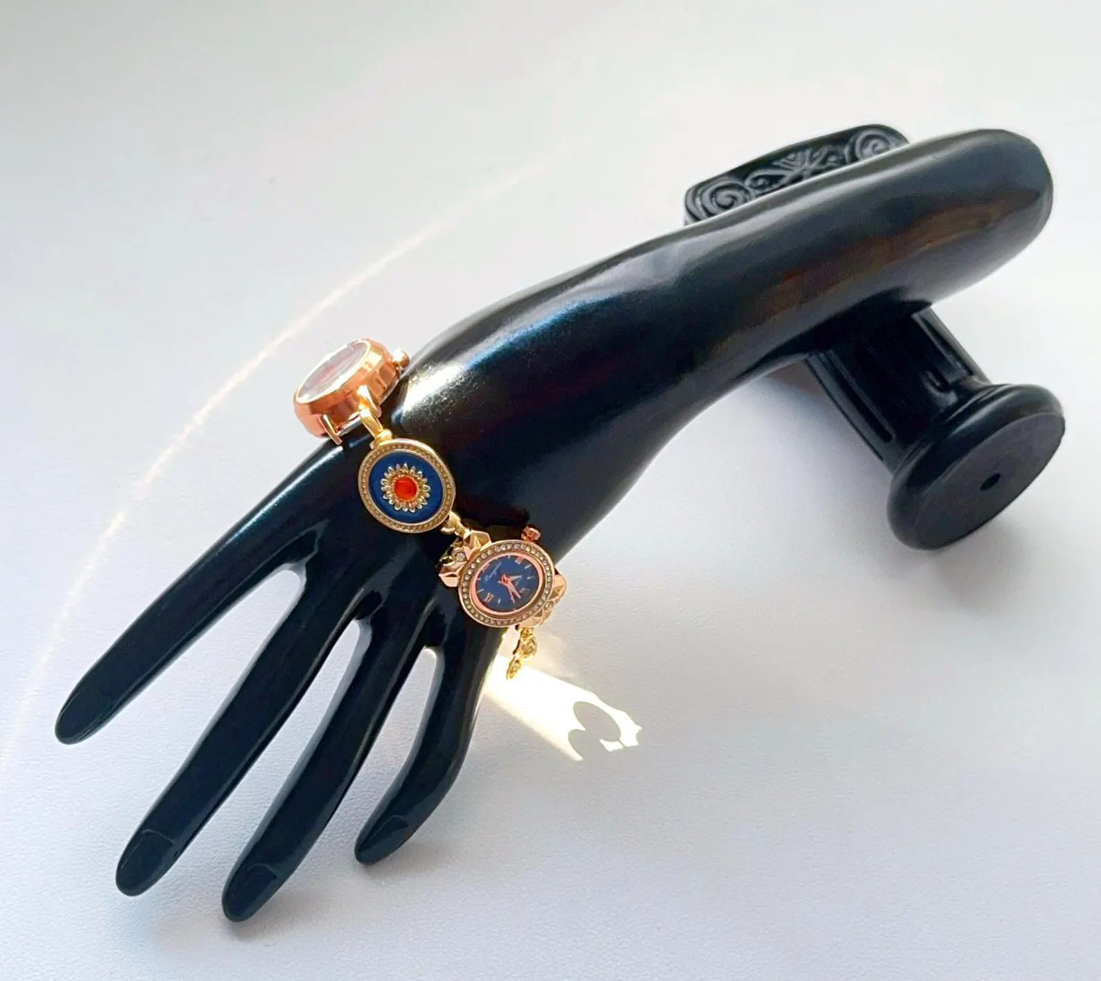 Bracelet watch built in stainless steel emphasizing charm hangpoints and central buttons