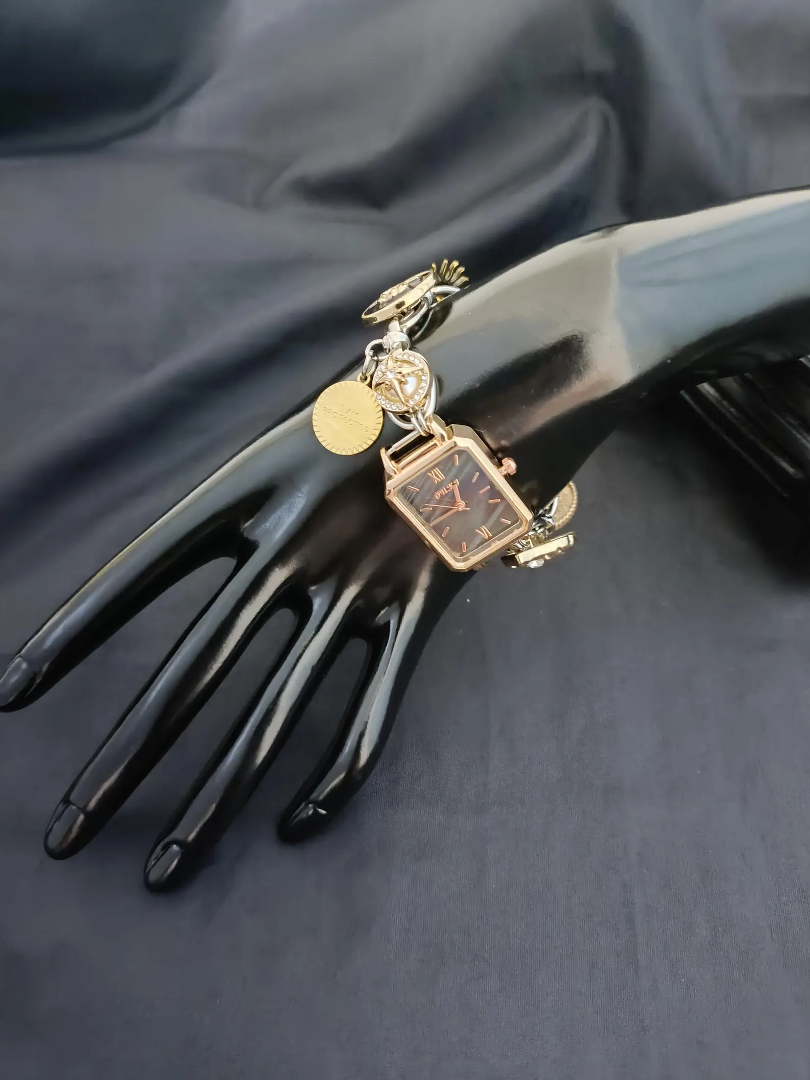 Digital-core bracelet watch crafted in titanium, interface buttons and swing charms