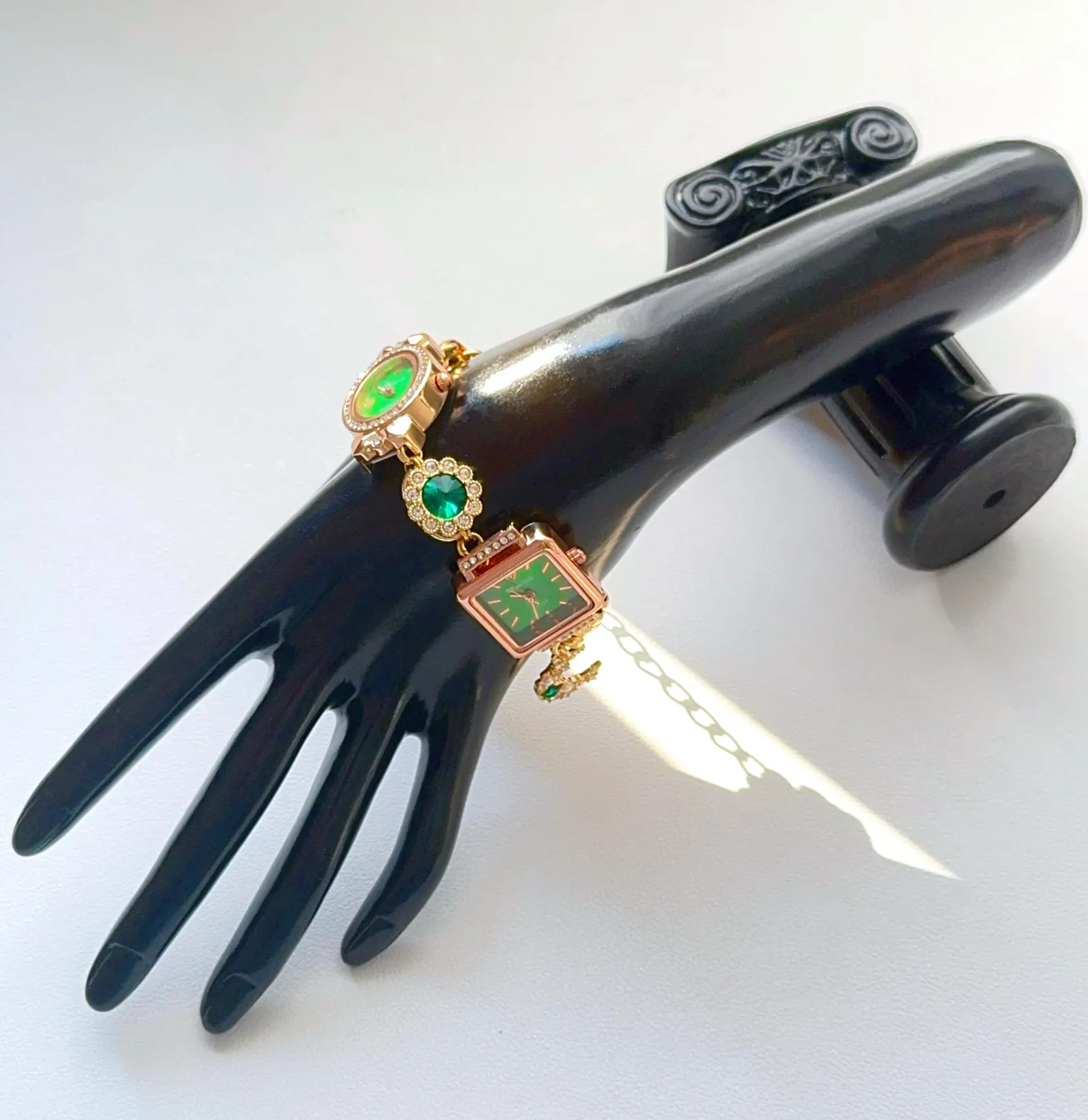 Metallic bracelet watch engineered from titanium with functional charm-button alignment