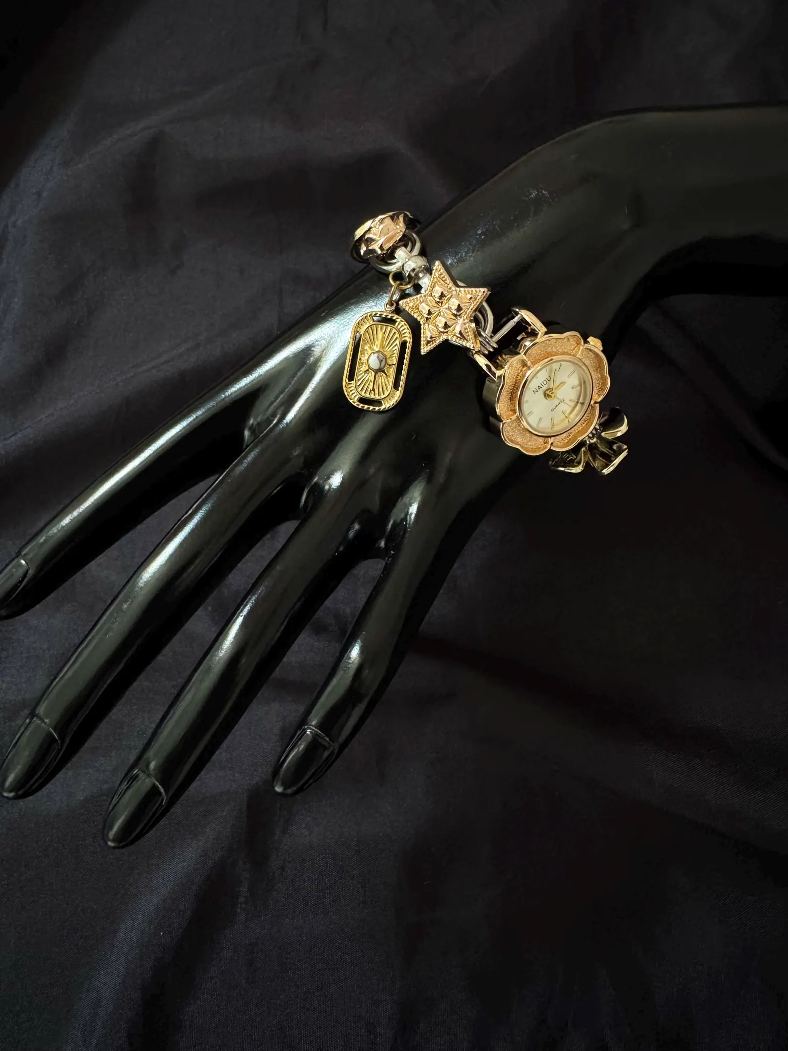 Statement wristwatch bracelet reflecting linear charm integration and button symmetry
