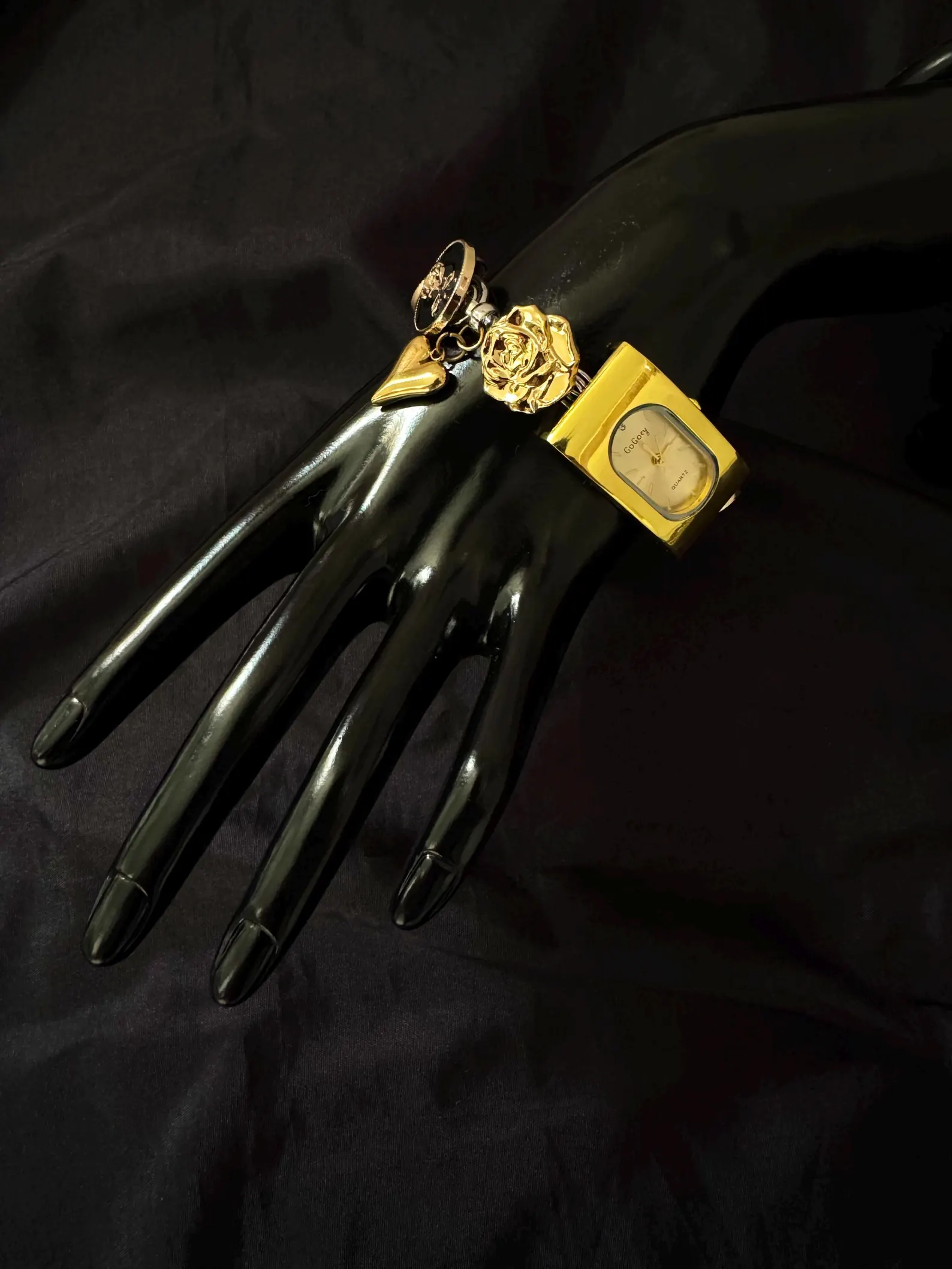 Cyberpunk gold watch choker with chunky chain and charm-studded buttons