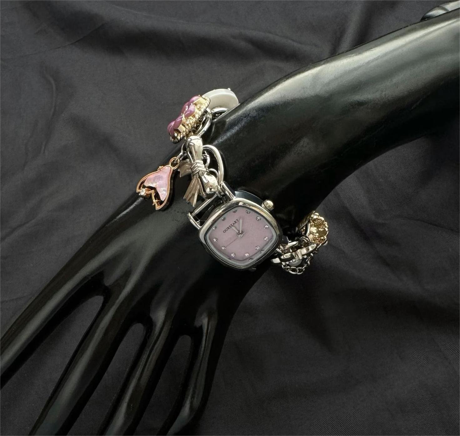 Ergonomic stainless steel bracelet watch created through charm balance and intuitive buttons