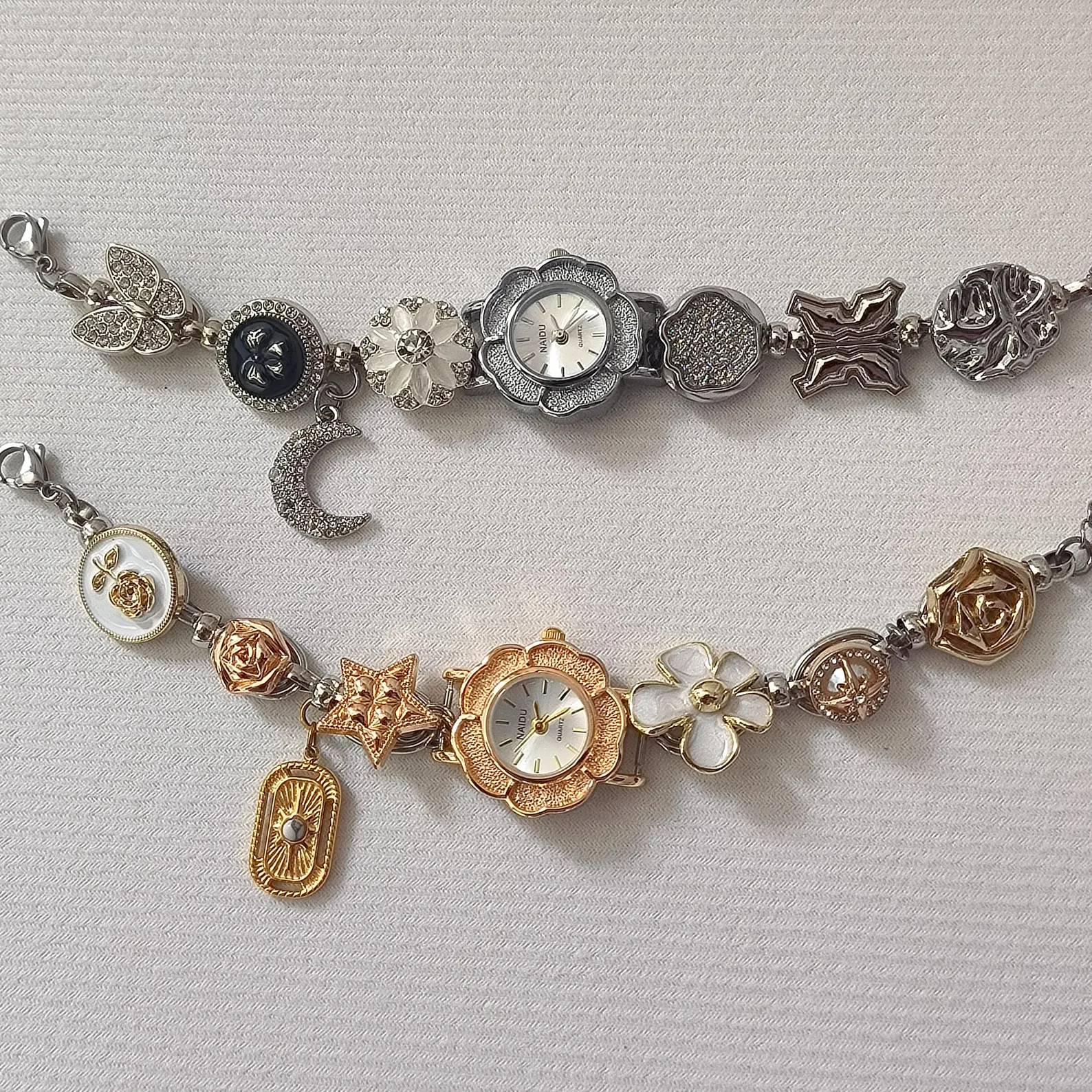 Fashion-focused stainless steel bracelet watch showing clean charm bars and soft button features