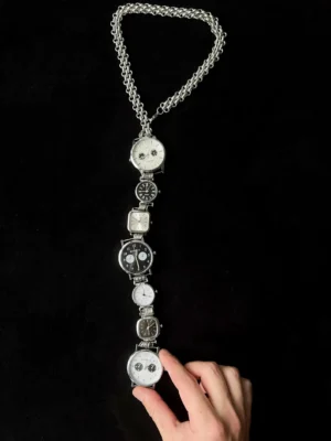 Futuristic unisex watch neckwear tie: A sleek, modern accessory featuring a functional mini watch on a stylish metallic chain, designed to be worn around the neck for a bold, tech-forward look.