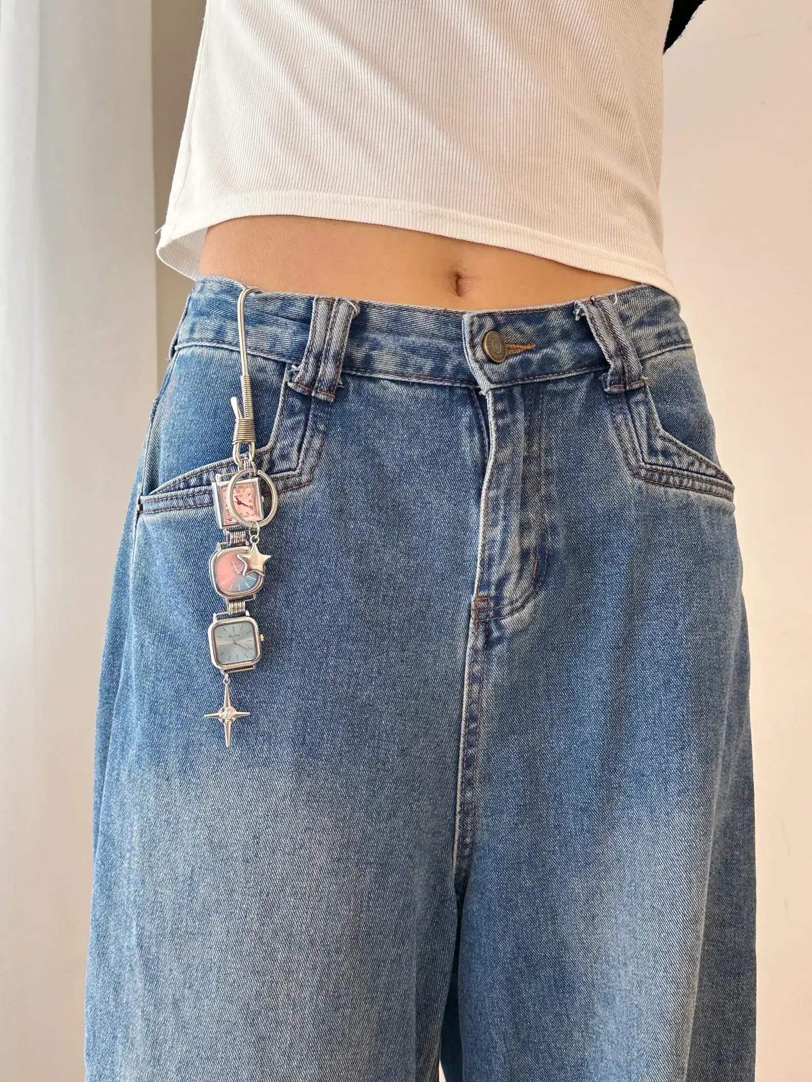 Y2K celebrity minimalist watch keychain: A sleek silver or black titanium chain with a small functional minimalist watch and subtle charm, worn as a keyring accessory, capturing the iconic early 2000s celebrity style with modern unisex appeal.