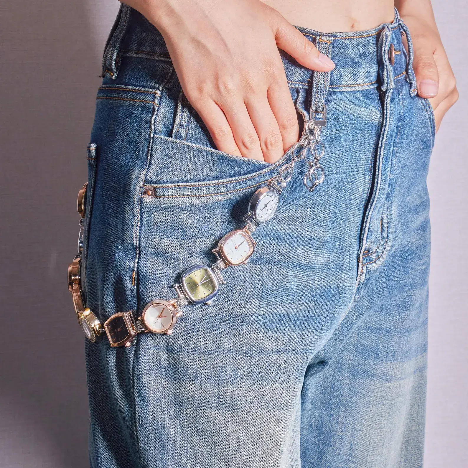 Bella Hadid Y2K Inspired Watch Bag Chain – silver metallic chain with vintage watch charm, styled as a trendy crossbody or handbag accessory, capturing early 2000s celebrity fashion.