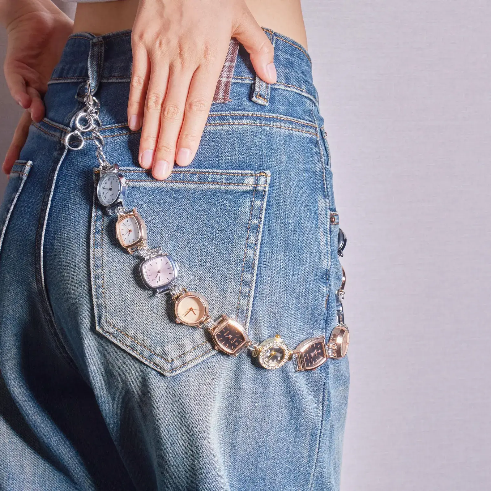Bella Hadid Y2K Inspired Watch Bag Chain – silver metallic chain with vintage watch charm, styled as a trendy crossbody or handbag accessory, capturing early 2000s celebrity fashion.