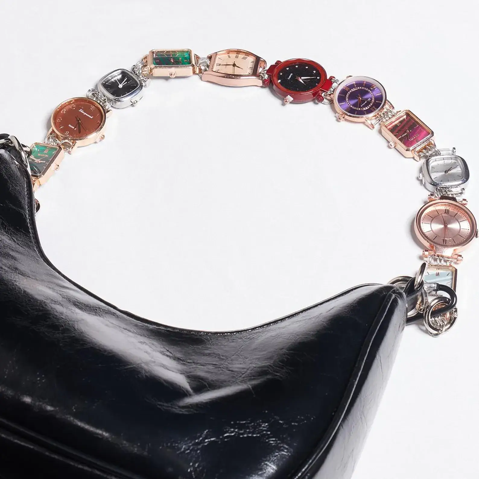 High fashion Prada titanium watch bag chain: Close-up of a sleek, polished titanium chain with Prada's iconic logo charm, featuring an adjustable clasp and versatile design that can be worn as a luxury watch strap or attached to handbags for an instant touch of high-end style.