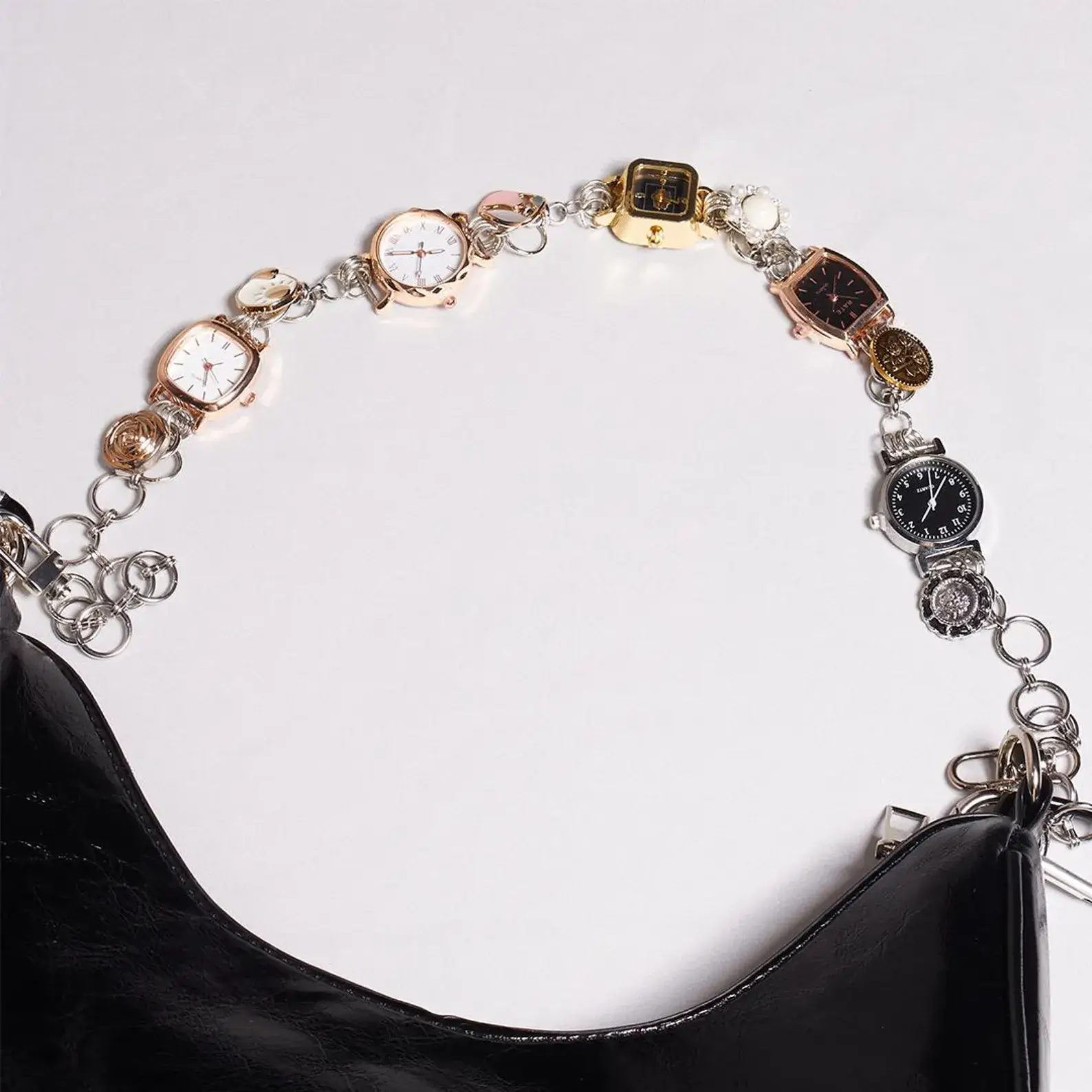 Adjustable stainless steel watch bag chain: Close-up of a durable silver stainless steel chain with a secure lobster clasp and multiple link connection points, shown worn as a watch strap and attached to a bag, highlighting its versatile and functional design.