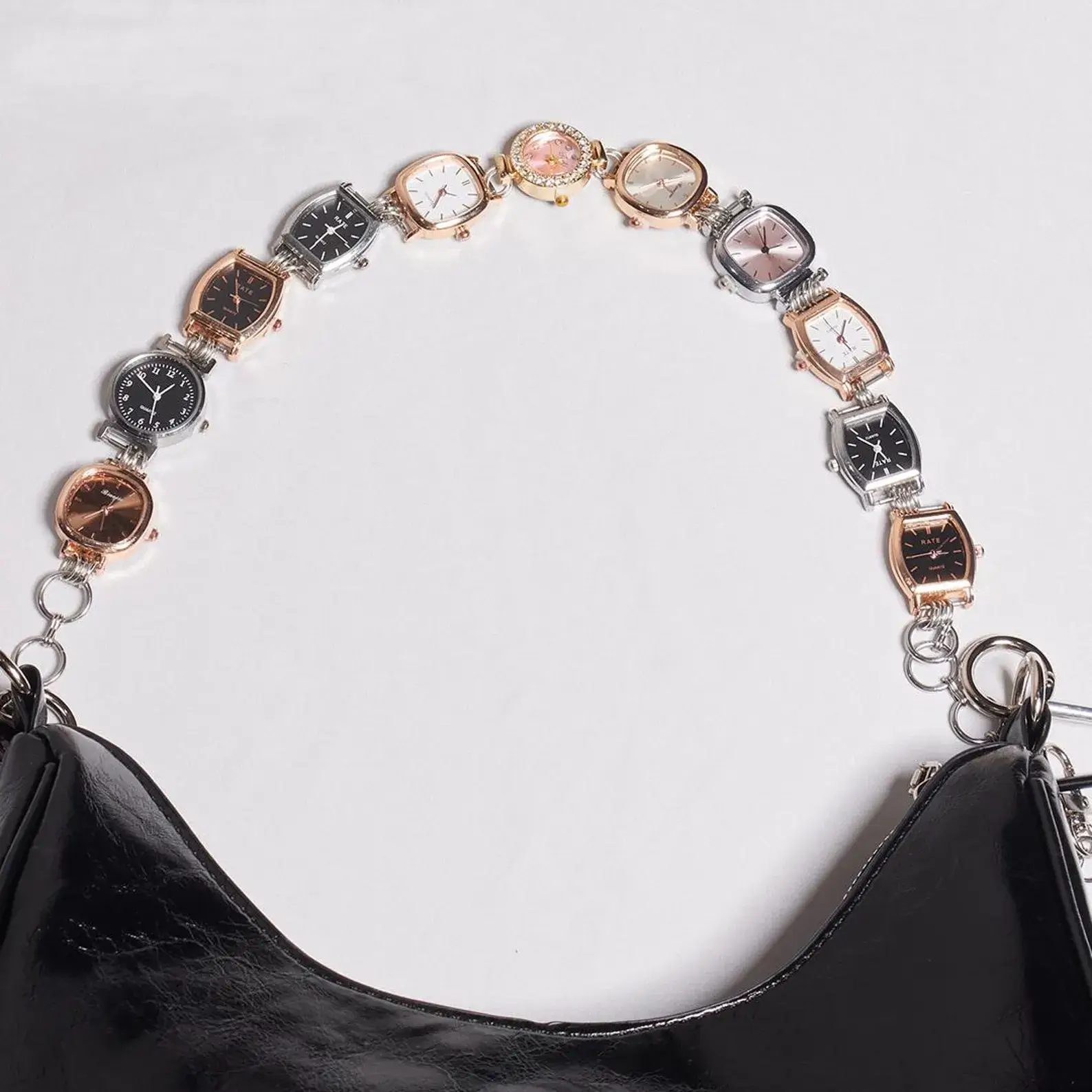 Close-up of Diesel Y2K Titanium Watch Bag Chain Accessory: Brushed silver titanium chain, adjustable length, DIESEL logo charm, retro-futuristic style, for watch or bag decoration.
