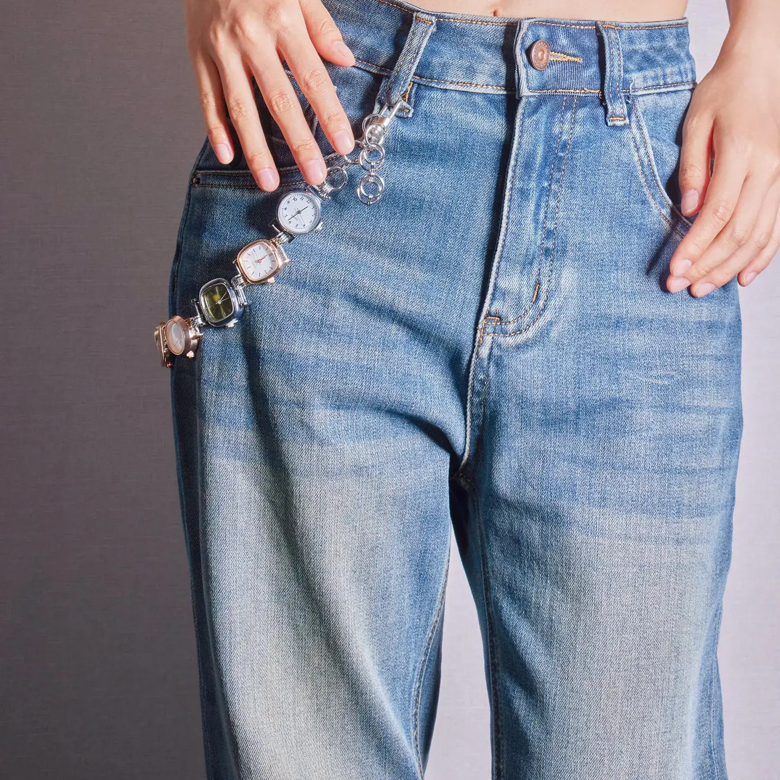 Bella Hadid Y2K Inspired Watch Bag Chain – silver metallic chain with vintage watch charm, styled as a trendy crossbody or handbag accessory, capturing early 2000s celebrity fashion.