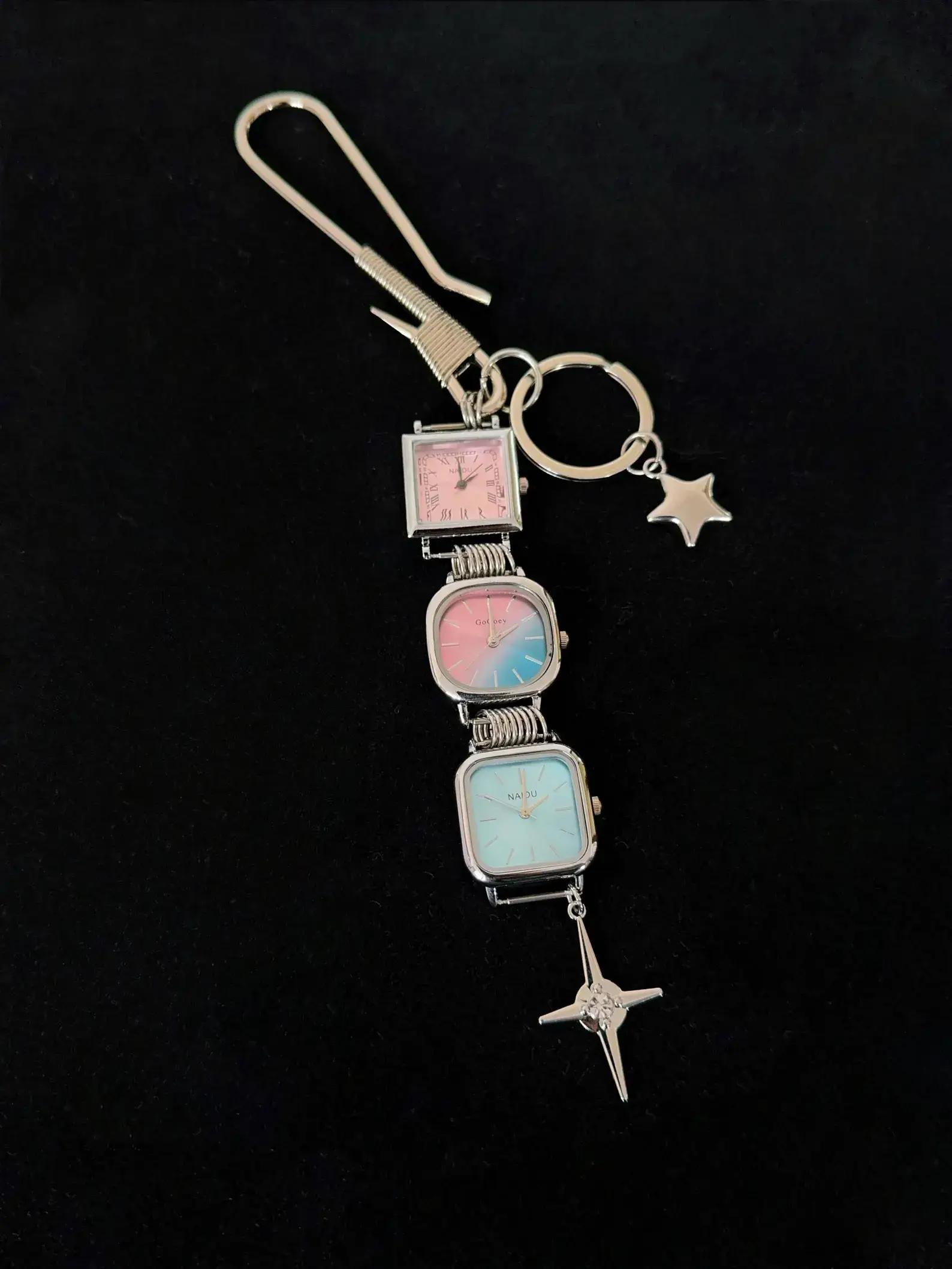 Y2K celebrity minimalist watch keychain: A sleek silver or black titanium chain with a small functional minimalist watch and subtle charm, worn as a keyring accessory, capturing the iconic early 2000s celebrity style with modern unisex appeal.
