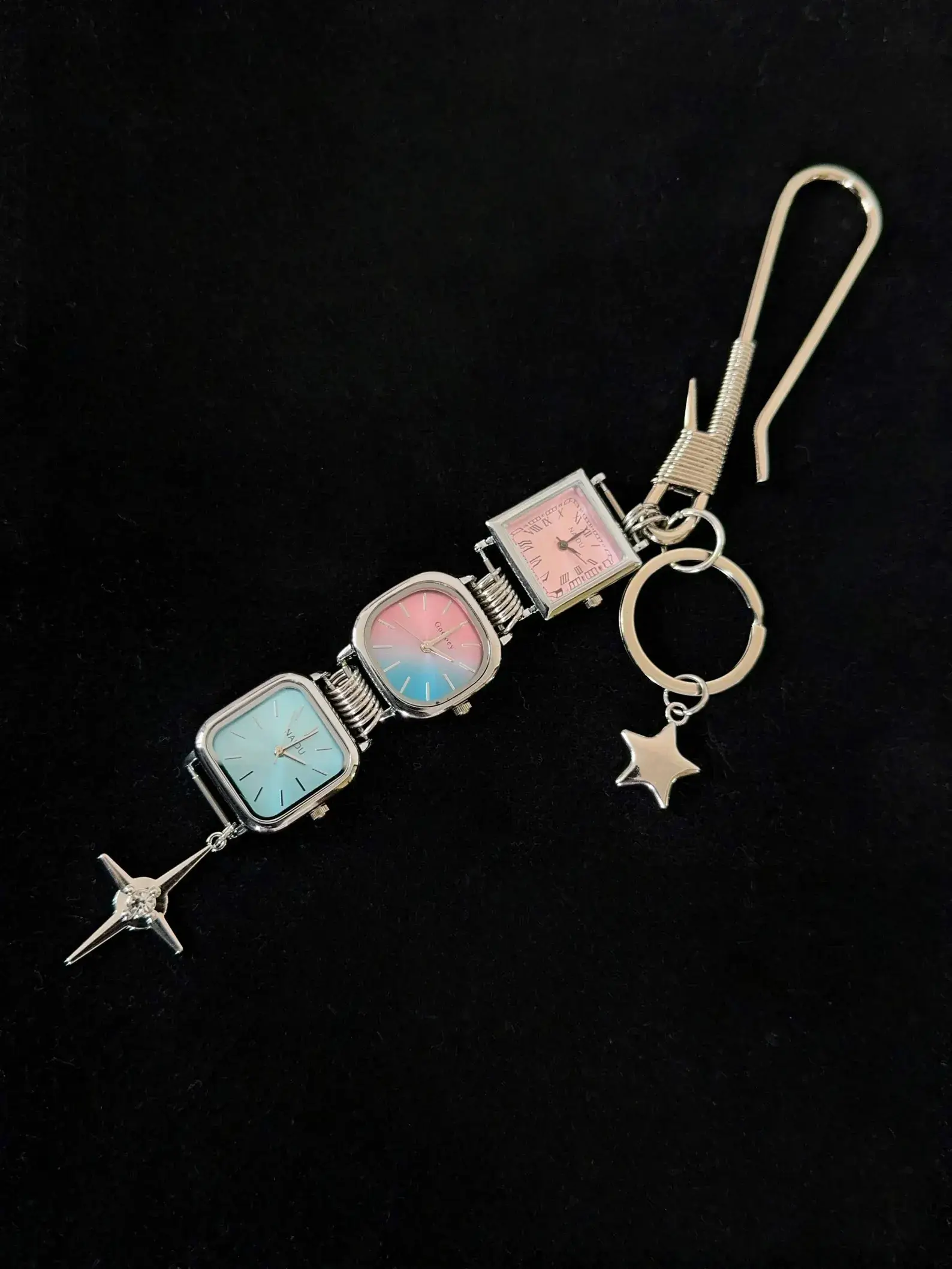 Y2K celebrity minimalist watch keychain: A sleek silver or black titanium chain with a small functional minimalist watch and subtle charm, worn as a keyring accessory, capturing the iconic early 2000s celebrity style with modern unisex appeal.